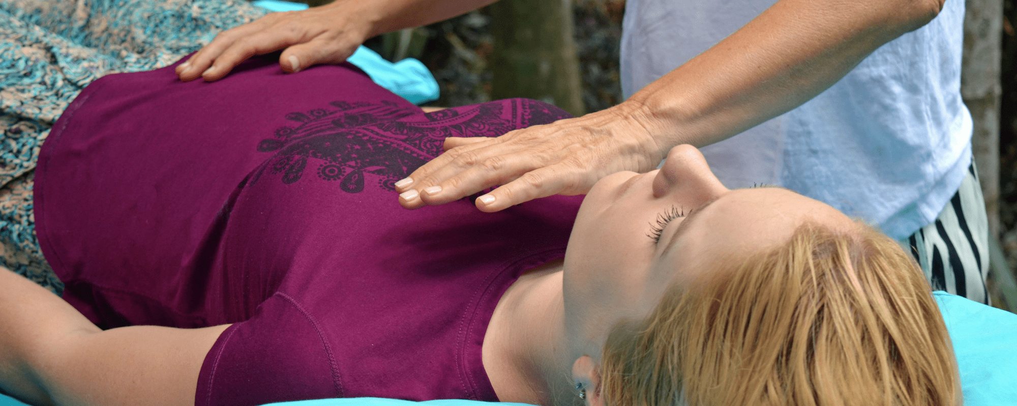 Reiki master Julie Heskins conducting a reiki treatment in Cairns