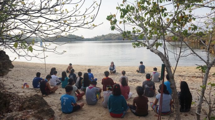 group meditation class on the beach in the philippines