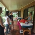 Julie Heskins instructing a group of Reiki students in hand positions