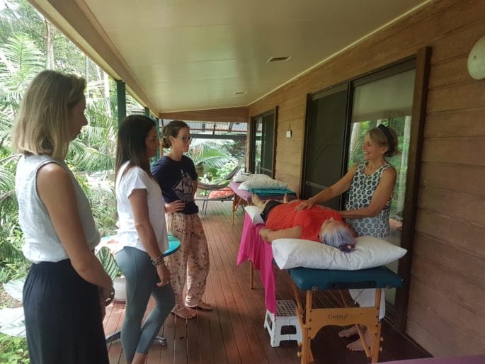 Julie Heskins instructing a group of Reiki students in hand positions
